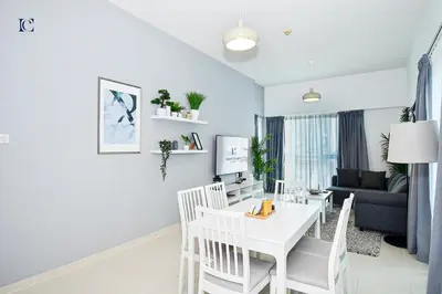 a living room with a white table and chairs at Luxury Escapes - Stylish 1BR Apartment - Close to Metro in Dubai Marina - Cascade Tower in Dubai