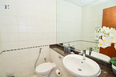 a bathroom with a toilet and a sink at Luxury Escapes - Stylish 1BR Apartment - Close to Metro in Dubai Marina - Cascade Tower in Dubai