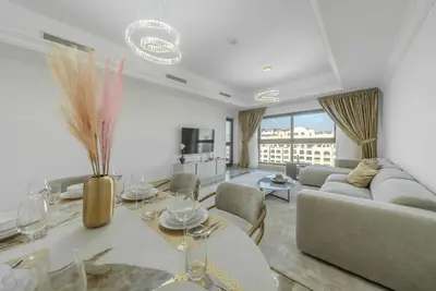 a living room with a couch and a table at Modern 1BR in Vibrant Fairmont North Residence - 90AB6 in Dubai
