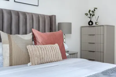 a bedroom with a bed with pillows and a headboard at GuestReady - Exquisite residence in Dubai Marina in Dubai