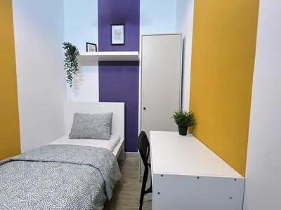 a bedroom with a bed and a desk with a mirror at Arch Partition Room Near Mall of the Emirates in Dubai