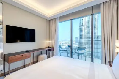 a hotel room with a large bed and a large window at Stunning Full Burj Khalifa View - The Address 2BR Luxury in Dubai