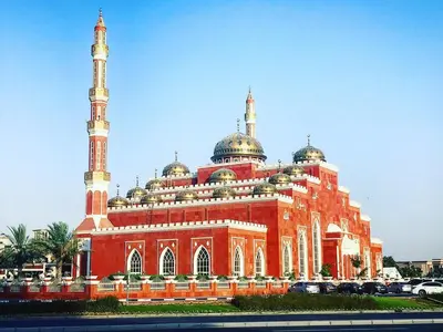 a large red building with domes and mosques at Beautiful Bedroom in Al Barsha Near Mashreq Metro in Dubai