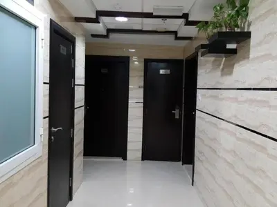 a hallway with two black doors in a building at Epic Partition Room in Barsha Near Metro in Dubai