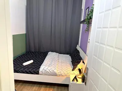 a small bed in a small room at Beautiful Double Partition Room in Tecom Near ICM Metro in Dubai