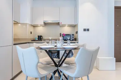 a dining room with a table and chairs at STAY BY LATINEM Luxury 1BR Holiday Home CVR B2704 near Burj Khalifa in Dubai