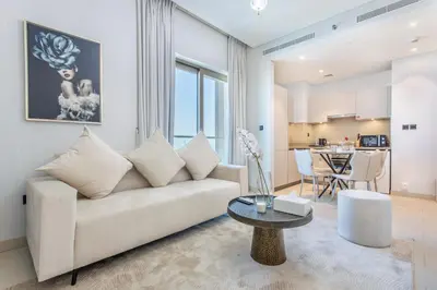 a living room with a couch and a table at STAY BY LATINEM Luxury 1BR Holiday Home CVR B2704 near Burj Khalifa in Dubai