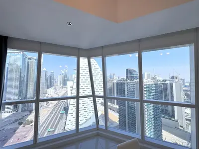 a room with a view of a city with tall buildings at Deluxe Apartment With Panoramic View Near Metro in Dubai