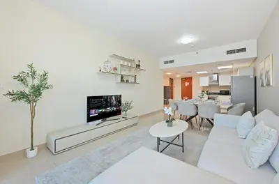 a living room with a white couch and a table at Difc 1 Bd apartment in Park Tower in Dubai