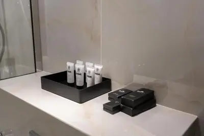 a bathroom counter with four electric toothbrushes on it at Lux BnB Princess Tower Palm Ocean Views in Dubai