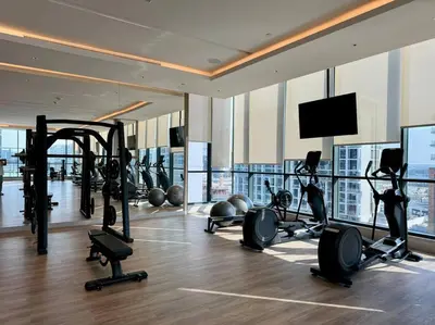 a gym with exercise equipment in a building at Stylish brand new 1 bedroom in Dubai