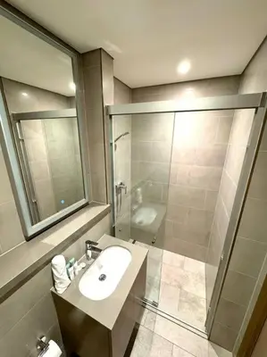 a bathroom with a sink and a shower at Stylish brand new 1 bedroom in Dubai