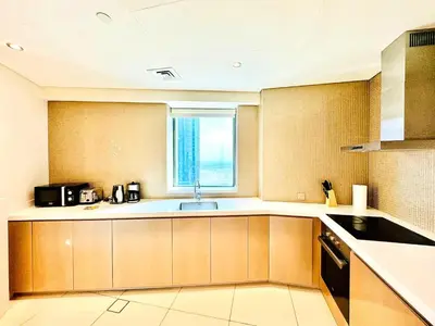 a large kitchen with a sink and a window at Paramount Towers - Elegant Home in Dubai