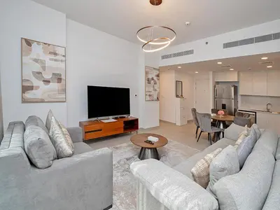 a living room with a couch and a flat screen tv at Brand new 2 Bedroom apartment in Madinat Jumeirah Living in Dubai