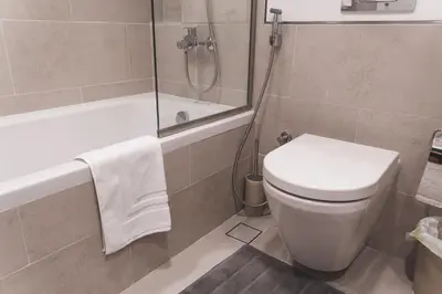 a bathroom with a shower and a toilet and a tub at New 2 bedroom entire apartment in Madinat Jumeirah Living in Dubai