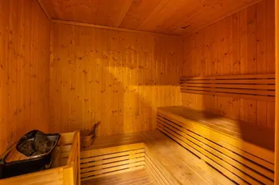 an empty sauna with wooden walls and wooden floors at Luxury Top Floor, with full Burj Khalifa View in Dubai