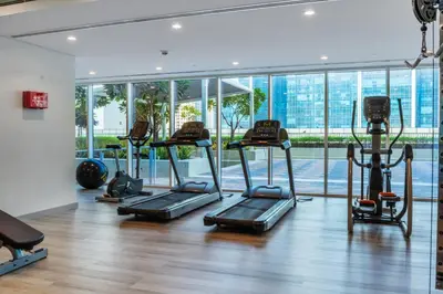a gym with cardio equipment and a large window at Luxury Top Floor, with full Burj Khalifa View in Dubai