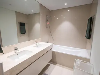 a bathroom with two sinks and a bath tub at MH - Act One Act Two - 2BHK - REF503 in Dubai