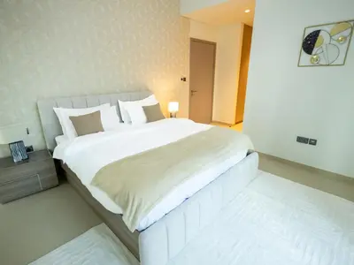 a bedroom with a large white bed in a room at MH - Act One Act Two - 2BHK - REF503 in Dubai
