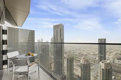 a balcony with a table and chairs and a view of a city at EDEN'S Homes & Villas - Address Opera District Residences in Dubai