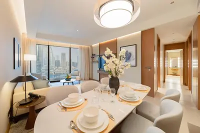 a dining room with a white table and chairs at EDEN'S Homes & Villas - Address Opera District Residences in Dubai