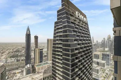 a tall building with a sign on the side of it at EDEN'S Homes & Villas - Address Opera District Residences in Dubai