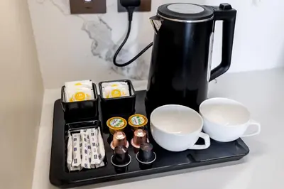 a black tray with cups and coffee cups on a counter at EDEN'S Homes & Villas - Address Opera District Residences in Dubai
