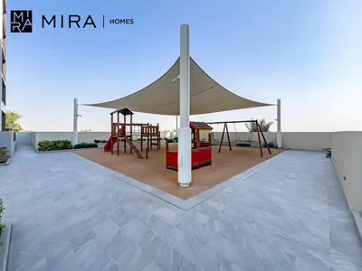 a canopy for a playground on a patio at Mira Holiday Homes - Fully furnished 1 bedroom in Creek Harbour in Dubai