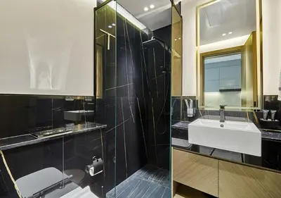 a bathroom with a sink and a shower at Lux Studio in Business Bay -10 mins to Burj Khalifa - Binghatti Canal in Dubai