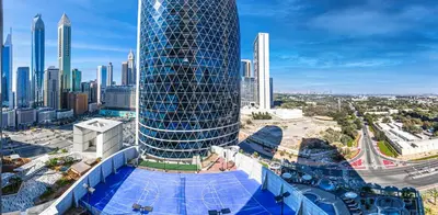 a tall blue building with a city in the background at Bright studio in DIFC near the metro station in Dubai