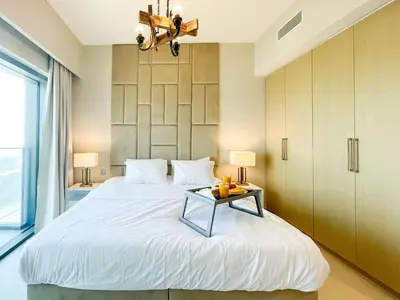 a bedroom with a large bed with a table on it at Beautiful apartment by Dubai Mall 161BR-2 in Dubai