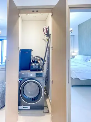 a washing machine in a room with a bed at Beautiful apartment by Dubai Mall 161BR-2 in Dubai
