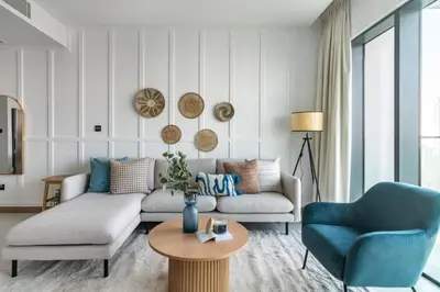 a living room with a couch and two chairs and a table at GuestReady - Opulent Residence in Dubai Marina in Dubai