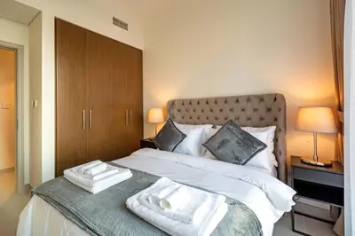 a bedroom with a bed with two towels on it at 2-Bedroom in the Heart of Downtown Dubai in Dubai