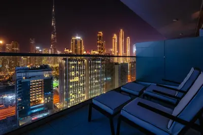 a room with a view of a city at night at Luxury Top Floor apt with Full Burj Khalifa view in Dubai