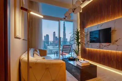 a living room with a couch and a large window at Luxury Top Floor apt with Full Burj Khalifa view in Dubai