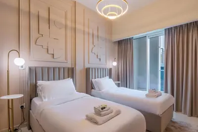 a hotel room with two beds and a window at Stylish high floor apartment with Burj View in Dubai