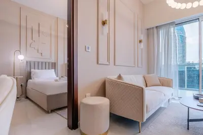 a living room with a couch and a bed at Stylish high floor apartment with Burj View in Dubai