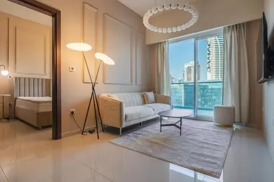a living room with a couch and a table at Stylish high floor apartment with Burj View in Dubai