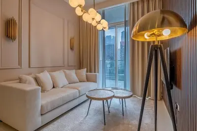 a living room with a couch and a table at Stylish Apartment 5 minutes from Dubai Mall with canal view in Dubai