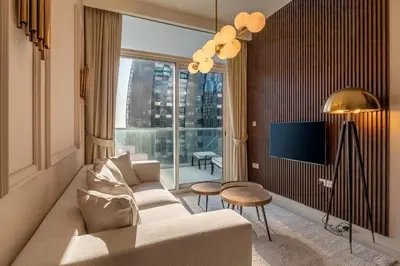 a living room with a couch and a large window at Stylish Apartment 5 minutes from Dubai Mall with canal view in Dubai