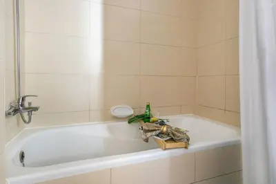 a bathroom with a bath tub with a faucet at Frank Porter - Elite 5 Sports Residence in Dubai