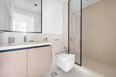 a bathroom with a toilet and a sink and a shower at Silkhaus Upscale 1BR by Burj Khalifa with Balcony in Dubai