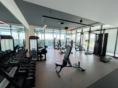 a gym with treadmills and exercise equipment and windows at StoneTree - New Luxury Apartment with Private Beach in Dubai