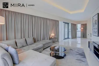 a living room with a couch and a table at Mira Holiday Homes - Furnished 1 bedroom in Paramount Tower B in Dubai
