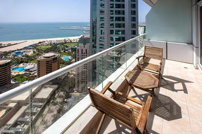 two chairs sitting on a balcony overlooking the ocean at Nice view apartment in Botanica Tower Dubai Marina in Dubai