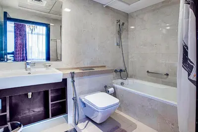 a bathroom with a sink and a toilet and a tub at Nice view apartment in Botanica Tower Dubai Marina in Dubai