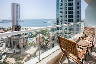 a balcony with two chairs and a view of the ocean at Nice view apartment in Botanica Tower Dubai Marina in Dubai