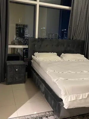 a large bed in a room with a window at Spacious Flat in Dubai Downtown in Dubai