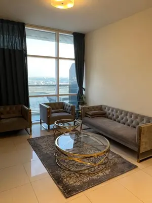 a living room with a couch and a glass table at Spacious Flat in Dubai Downtown in Dubai